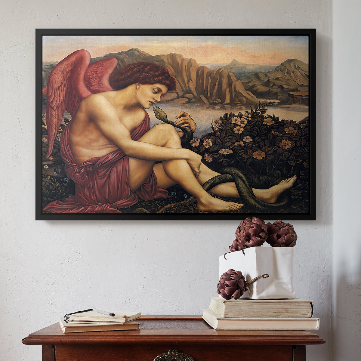 Black floater framed canvas featuring The Angel with the Serpent, c. 1870-1875 by Evelyn De Morgan above an entryway table in a minimalist foyer.