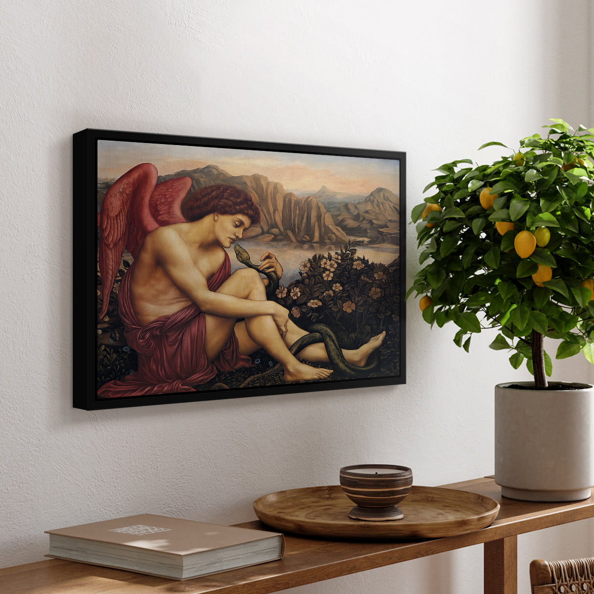 The Angel with the Serpent, c. 1870-1875 by Evelyn De Morgan, presented in a black floater framed canvas featuring an angelic figure confronting serpent in symbolic battle of good and evil, displayed above a hallway console table.