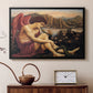 Black floater framed canvas featuring a religious scene with angel defeating snake in dramatic pose, displayed above a cabinet in a soft-toned living room.