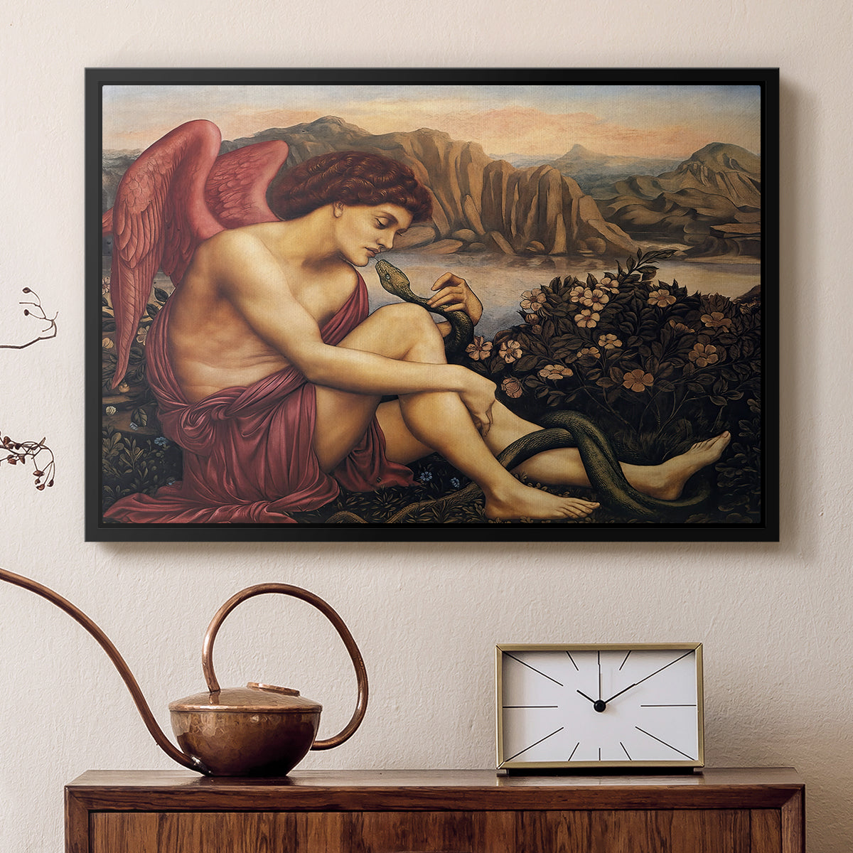 Black floater framed canvas featuring a religious scene with angel defeating snake in dramatic pose, displayed above a cabinet in a soft-toned living room.