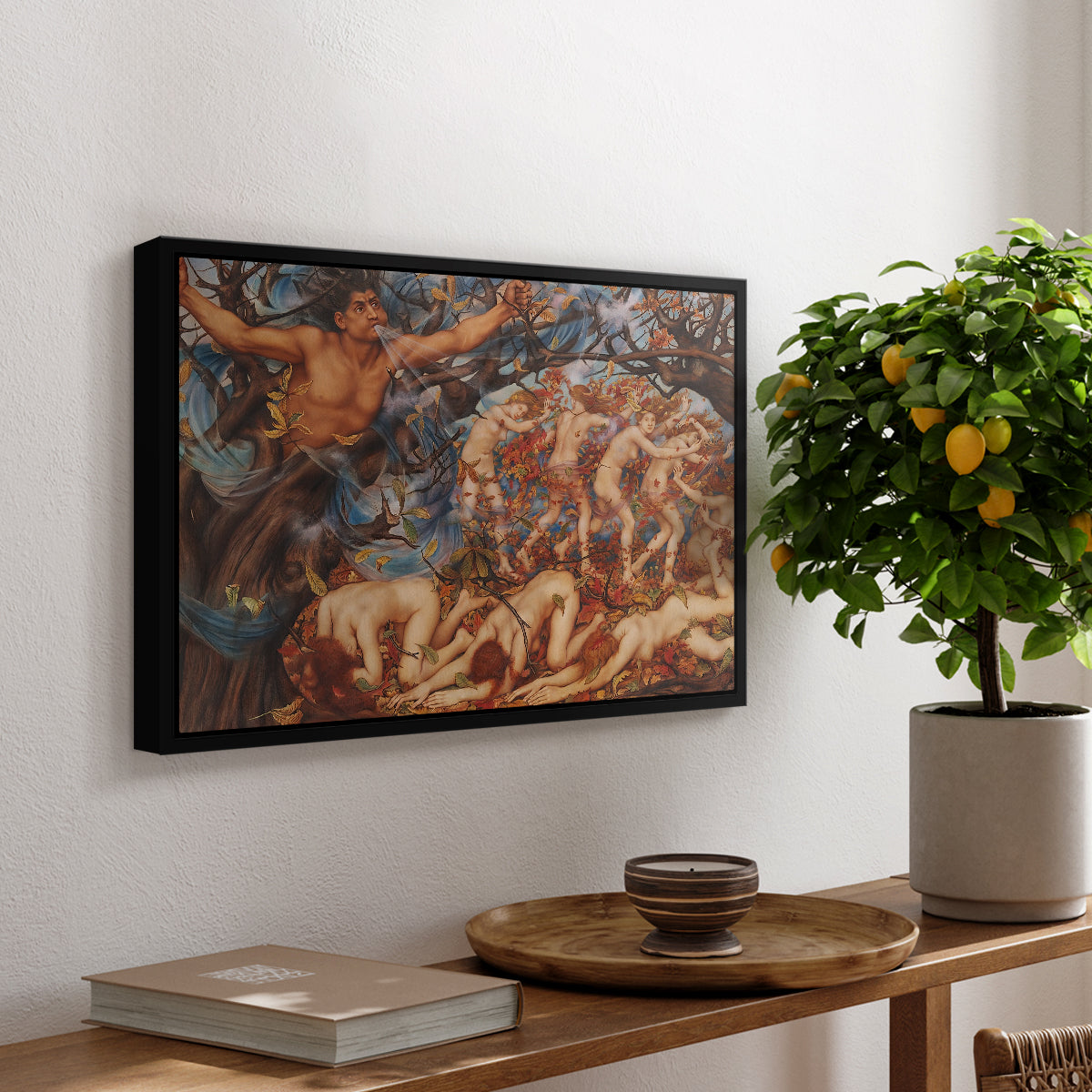 Boreas and the Fallen Leaves, c. 1910-1914 by Evelyn De Morgan, presented in a black floater framed canvas featuring swirling figures carried by wind among falling leaves in dynamic composition, displayed above a hallway console table.