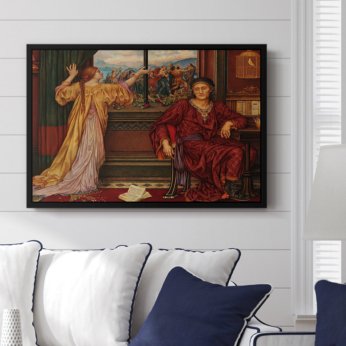 The Gilded Cage, c. 1901-1902 by Evelyn De Morgan displayed above a sofa in a living room in a black floater frame, featuring a symbolic scene of figure enclosed within decorative surroundings.