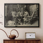 Black floater framed canvas featuring an intimate interior with players focused on board and pieces, displayed above a cabinet in a soft-toned living room.