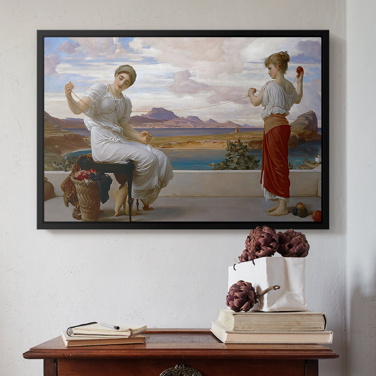 Black floater framed canvas featuring Winding the Skein, c. 1878 by Frederic Leighton above an entryway table in a minimalist foyer.