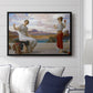 Winding the Skein, c. 1878 by Frederic Leighton displayed above a sofa in a living room in a black floater frame, featuring two women engaged in textile work with draped garments.