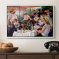 Luncheon of the Boating Party (Le Déjeuner des canotiers), 1880-1881 by Pierre-Auguste Renoir in a white floater framed canvas displayed above a console table in a hallway, featuring a social dining scene with figures seated around table on riverside terrace.