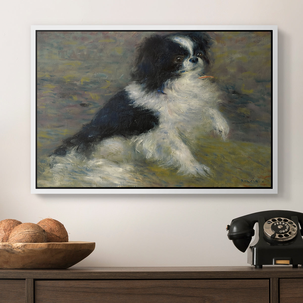 Tama, the Japanese Dog, c. 1876 by Pierre-Auguste Renoir in a white floater framed canvas displayed above a console table in a hallway, featuring an animal portrait of a dog in natural outdoor setting with soft light.