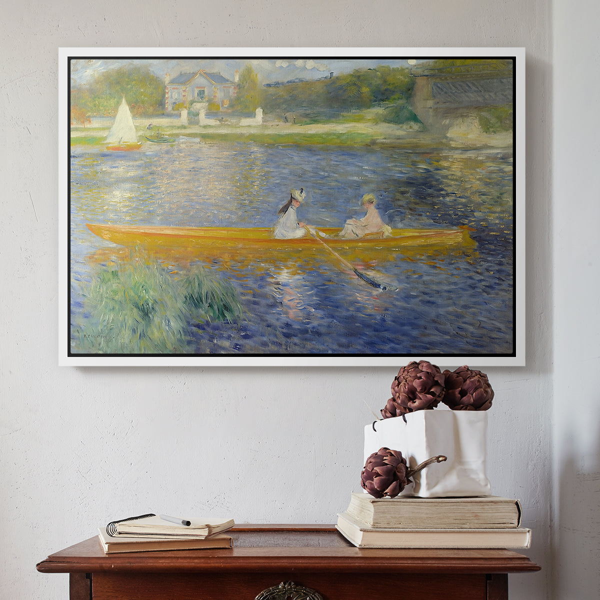 White floater framed canvas featuring The Skiff (La Yole), 1875 by Pierre-Auguste Renoir above an entryway table in a minimalist foyer.