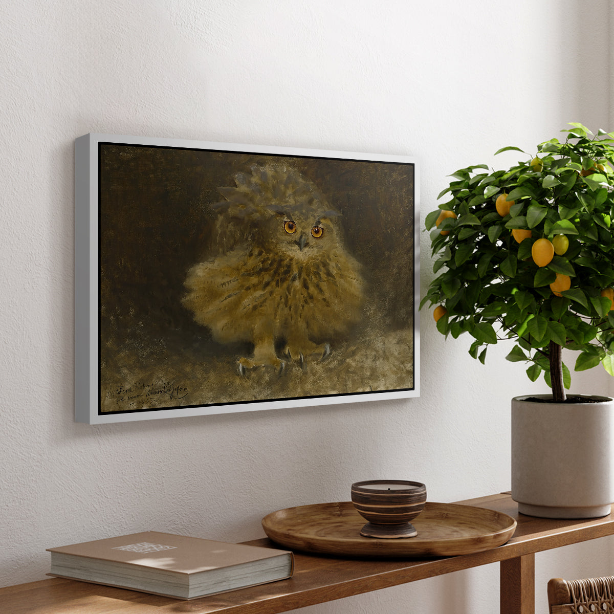 An Eagle Owl (Berguv), 1905 by Bruno Liljefors, presented in a white floater framed canvas featuring a large owl perched on branch in shadowy natural forest setting, displayed above a hallway console table.