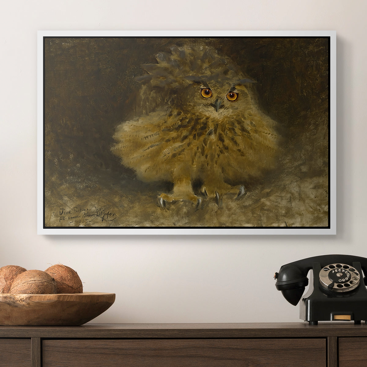 An Eagle Owl (Berguv), 1905 by Bruno Liljefors in a white floater framed canvas displayed above a console table in a hallway, featuring a realistic depiction of owl camouflaged within woodland environment.