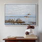 White floater framed canvas featuring Greylag Geese (Grågäss), 1922 by Bruno Liljefors above an entryway table in a minimalist foyer.