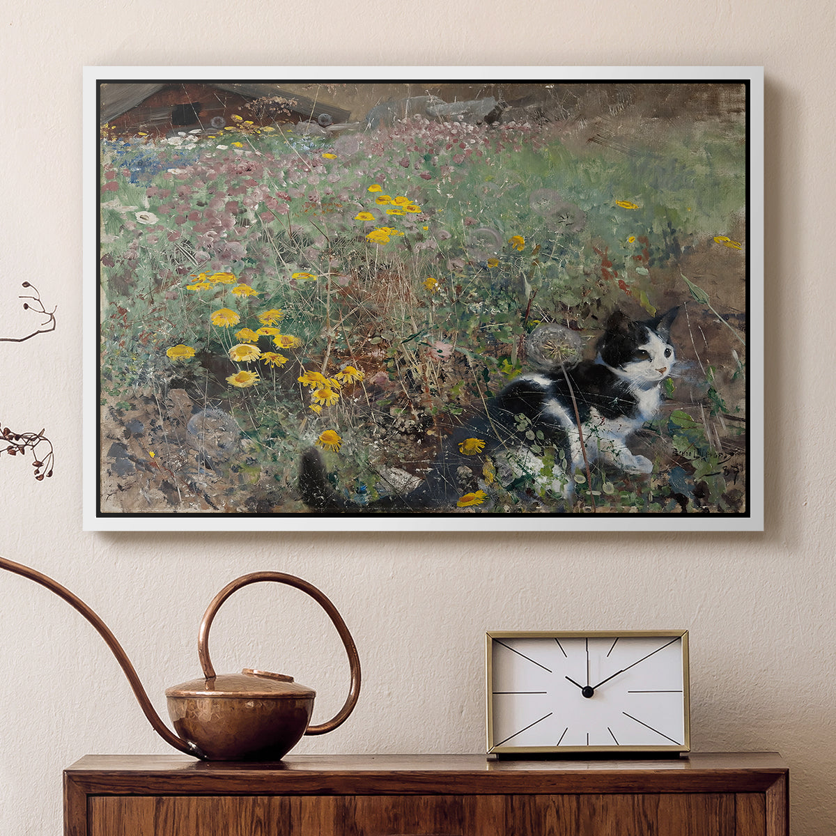 White floater framed canvas featuring an animal scene of cat hidden in lush meadow vegetation, displayed above a cabinet in a soft-toned living room.