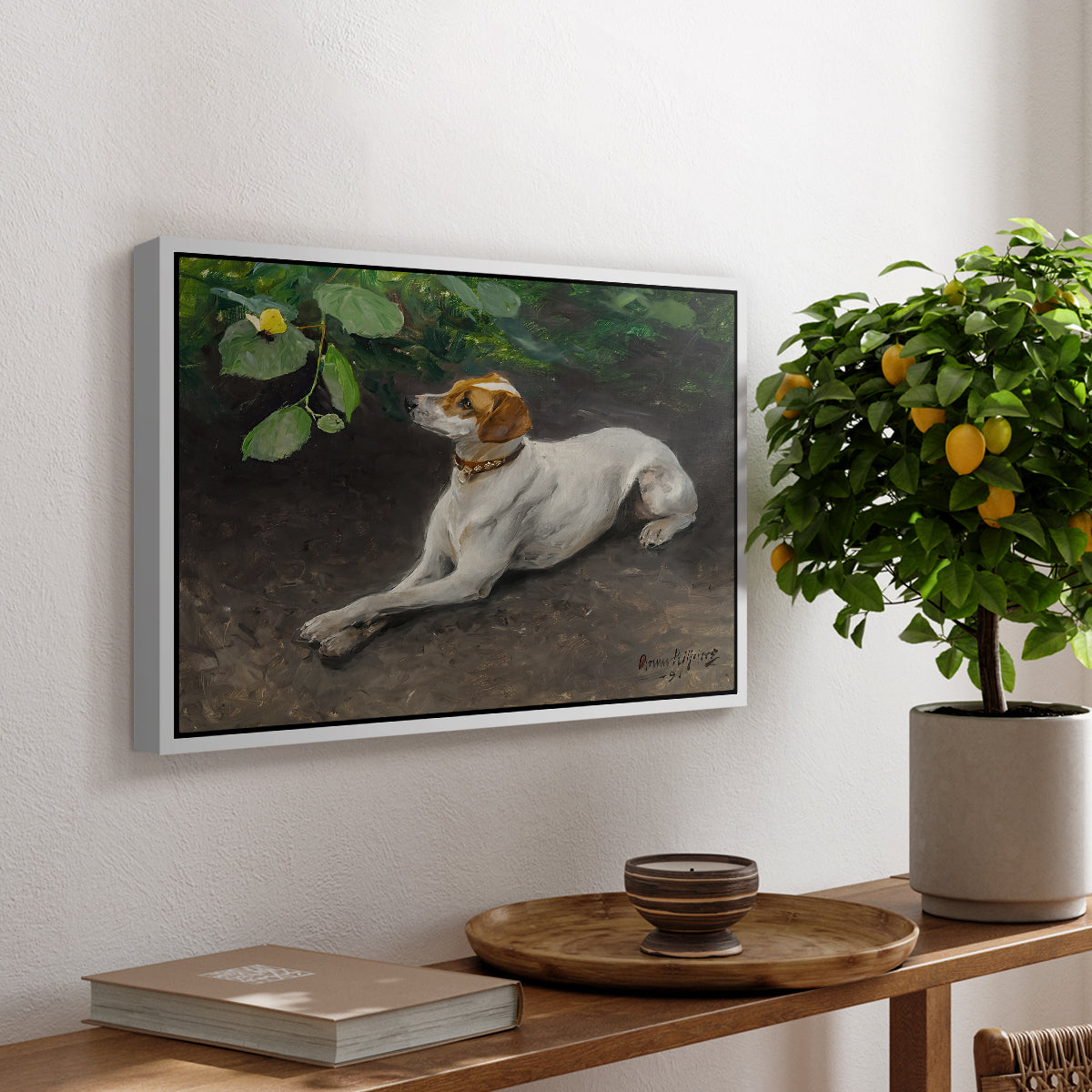 Portrait of a Dog, 1891 by Bruno Liljefors, presented in a white floater framed canvas featuring a dog lying on ground with head raised in natural outdoor setting, displayed above a hallway console table.