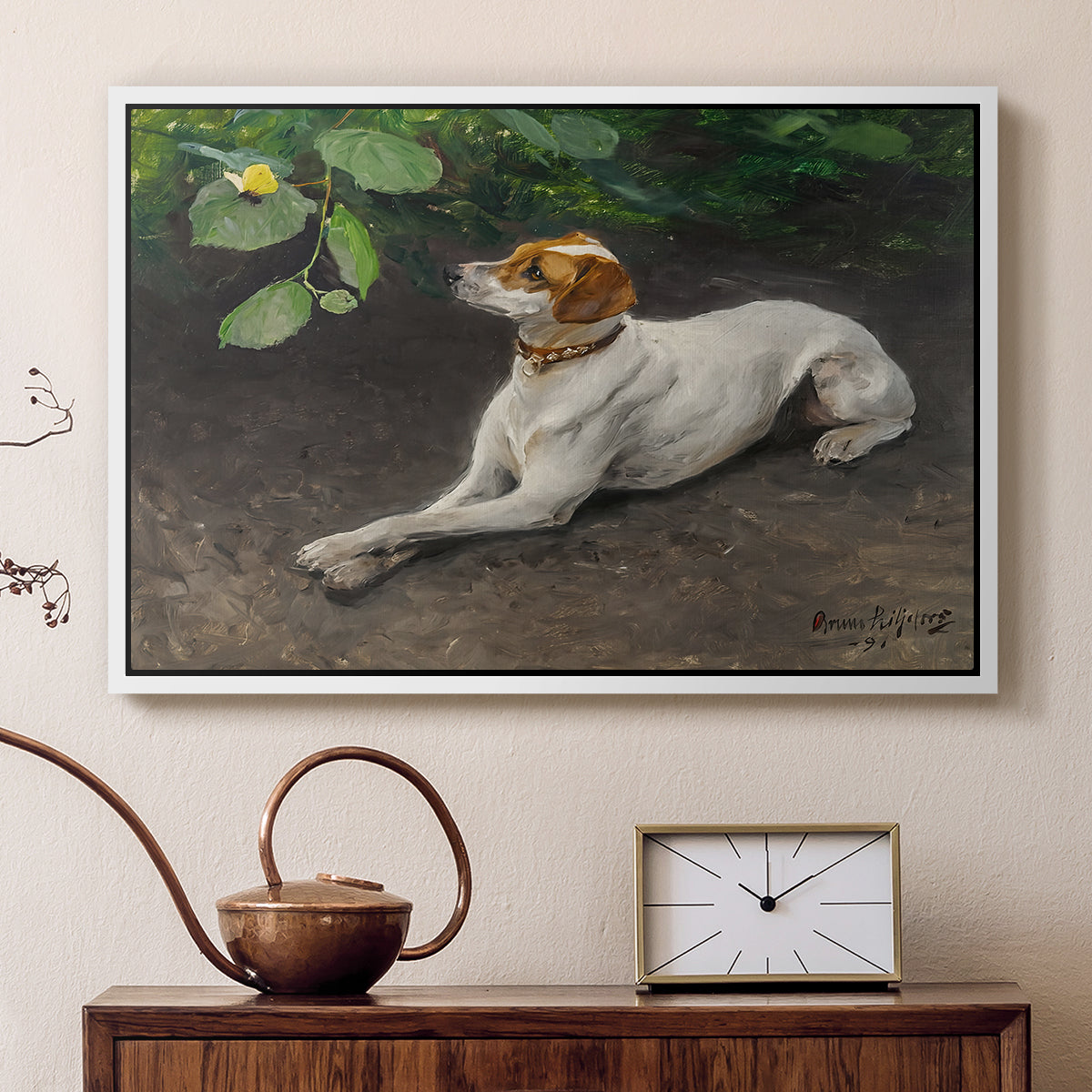 White floater framed canvas featuring an animal painting of dog stretched out on earthy terrain, displayed above a cabinet in a soft-toned living room.