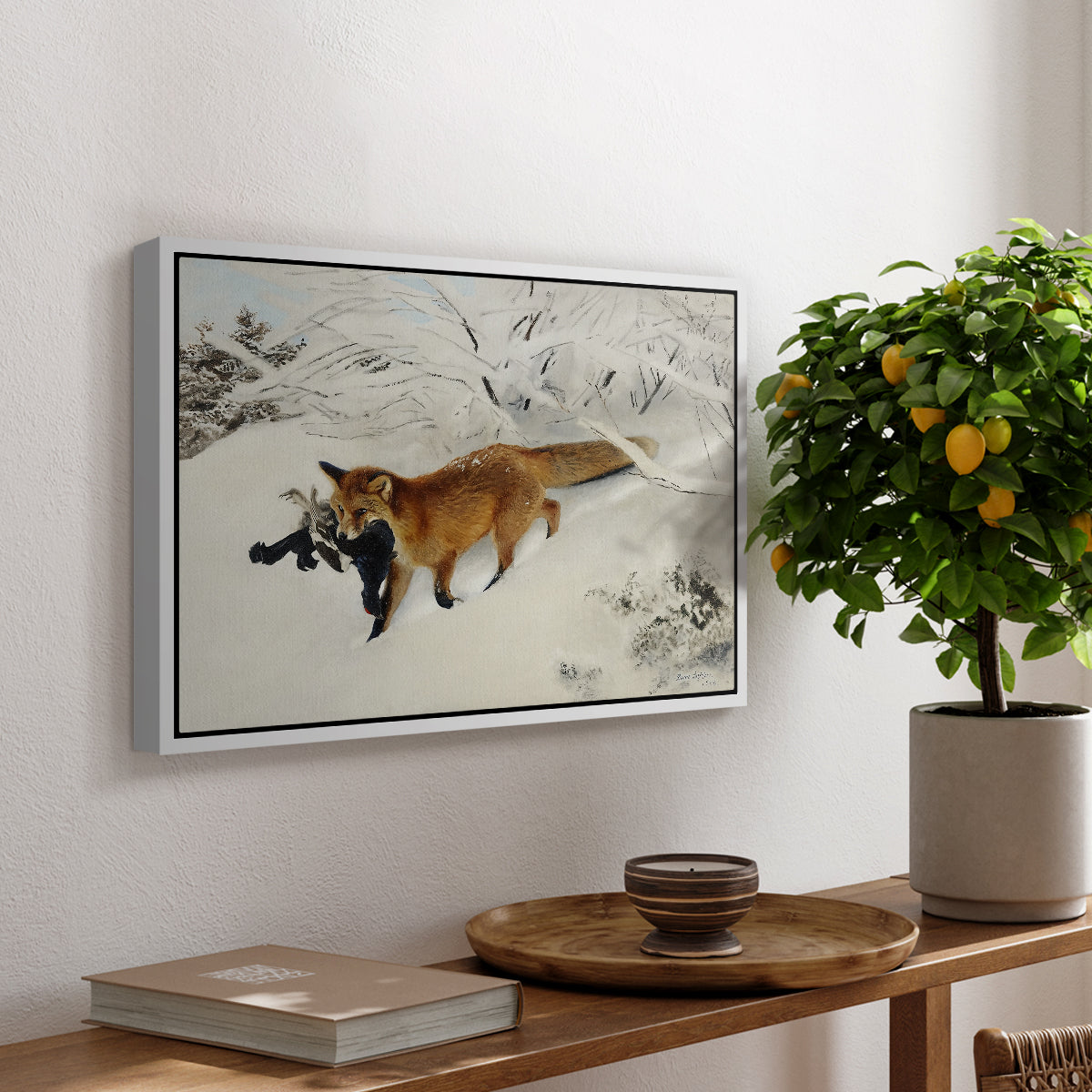 Fox in Snow Landscape, 1900 by Bruno Liljefors, presented in a white floater framed canvas featuring a fox running across snowy landscape with sparse vegetation, displayed above a hallway console table.