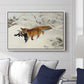 Fox in Snow Landscape, 1900 by Bruno Liljefors displayed above a sofa in a living room in a white floater frame, featuring a wildlife scene of fox moving swiftly through winter terrain.