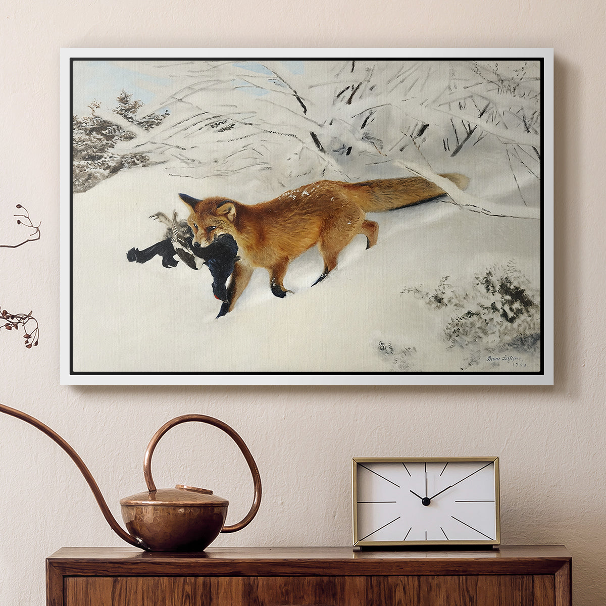 White floater framed canvas featuring a red fox crossing snow-covered ground under pale sky, displayed above a cabinet in a soft-toned living room.