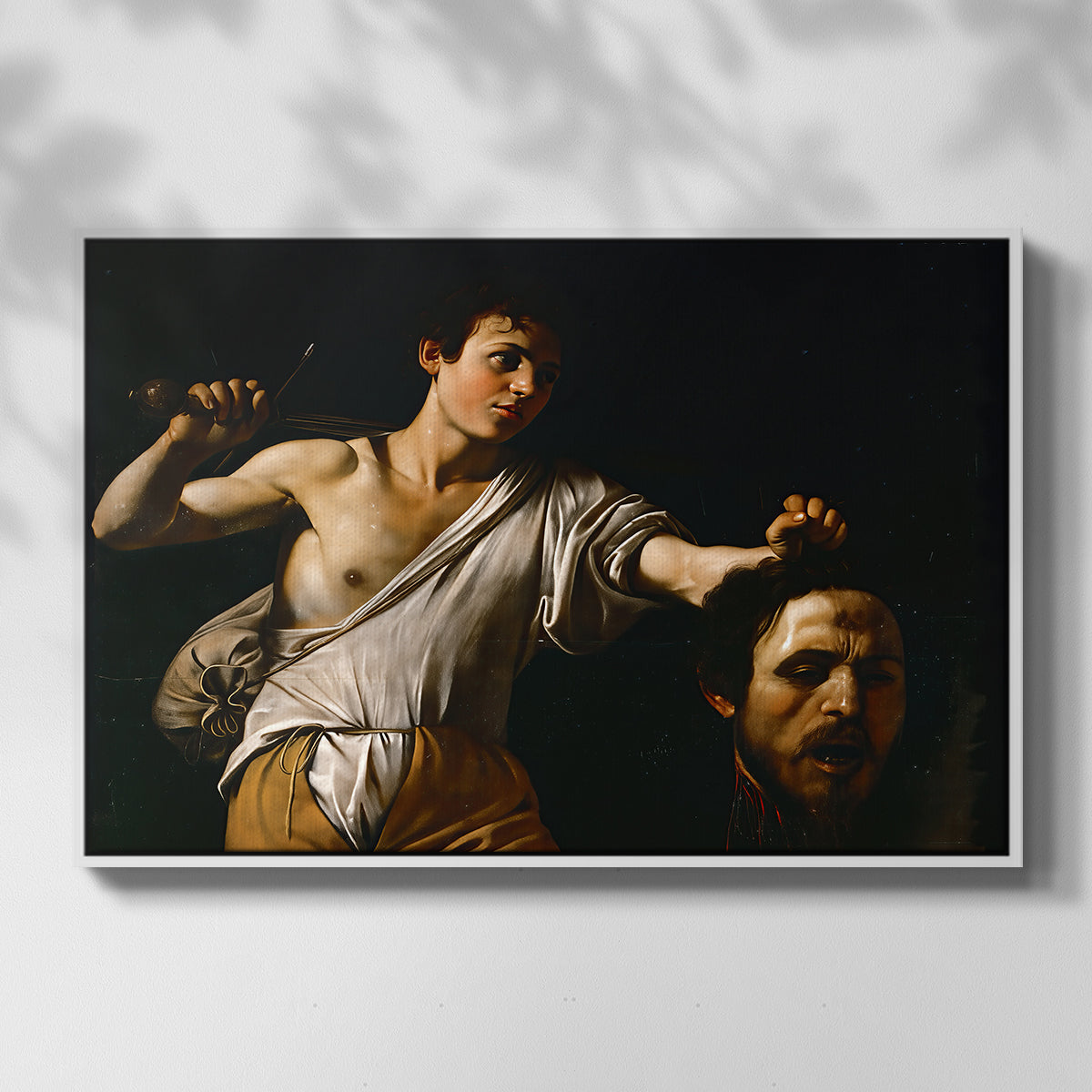 Front view of David with the Head of Goliath (Vienna Version), c. 1607 by Caravaggio in a white floater framed canvas.