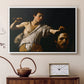 White floater framed canvas featuring a Baroque depiction of youth holding severed head in shadowy setting, displayed above a cabinet in a soft-toned living room.