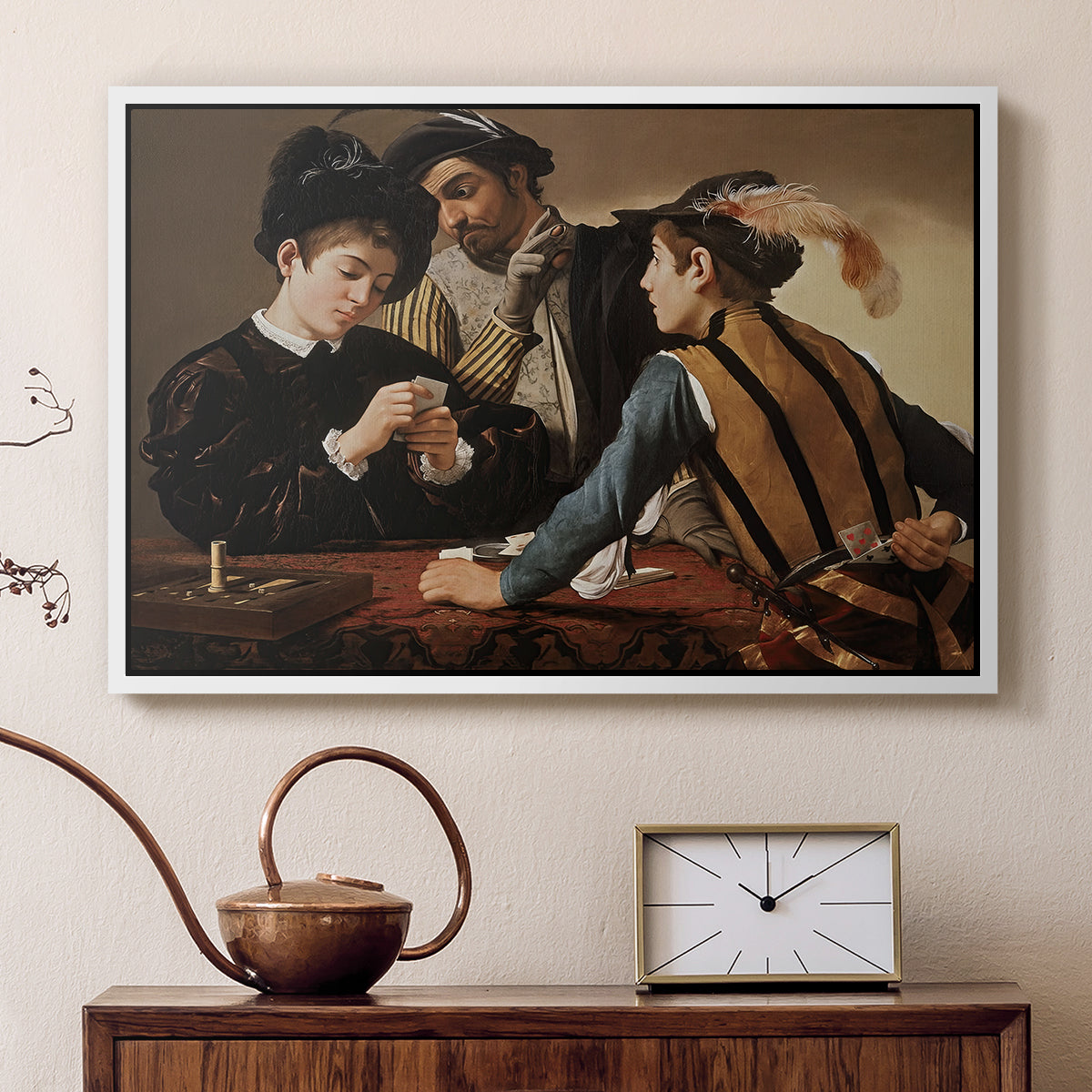 White floater framed canvas featuring a young men playing cards with one cheating and another watching closely, displayed above a cabinet in a soft-toned living room.