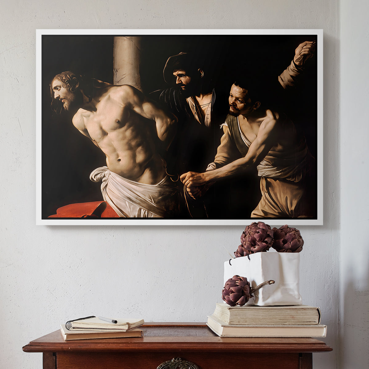 White floater framed canvas featuring The Flagellation of Christ at the Column (Rouen Version), 1606 by Caravaggio above an entryway table in a minimalist foyer.
