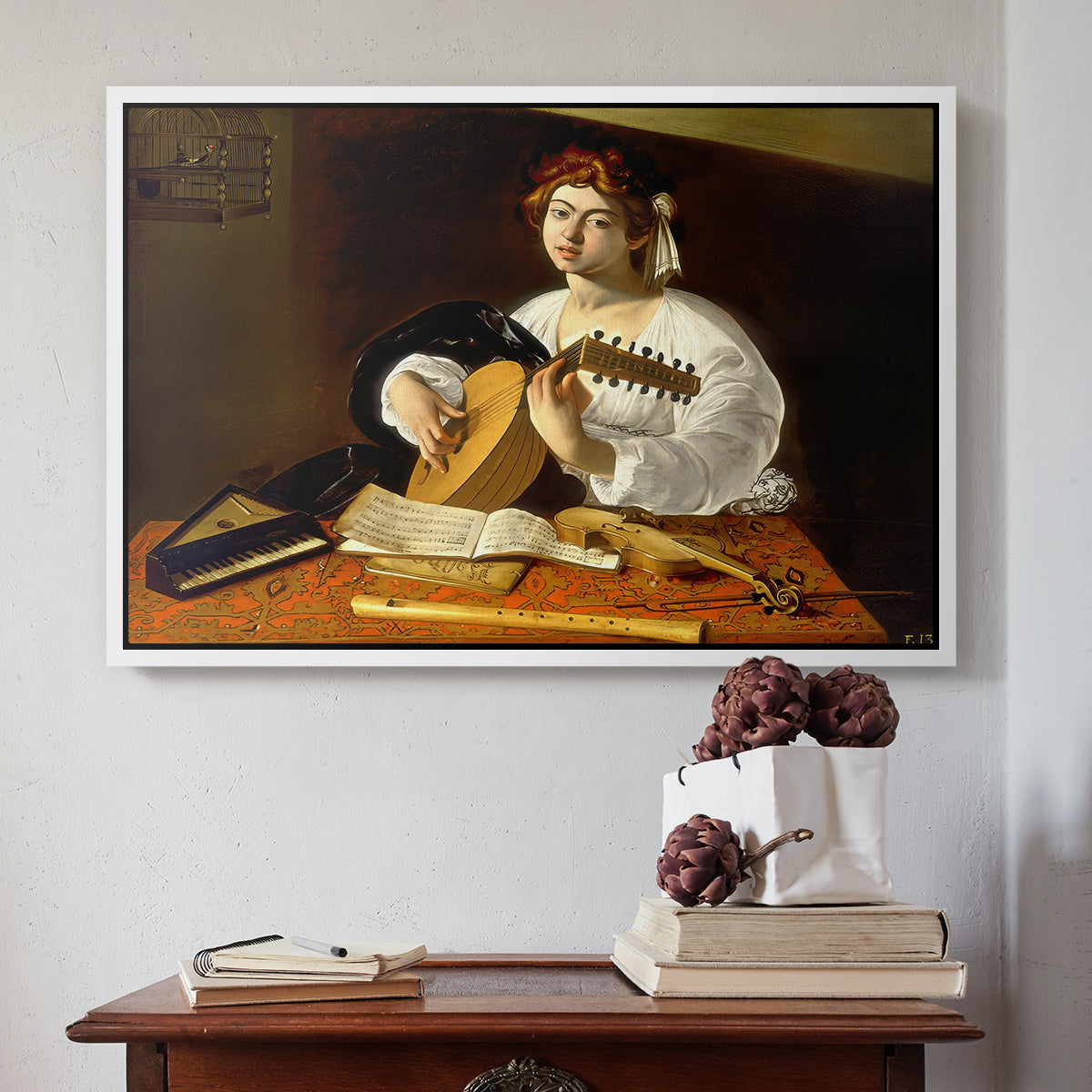 White floater framed canvas featuring The Lute Player (Wildenstein Version), c. 1596 by Caravaggio above an entryway table in a minimalist foyer.