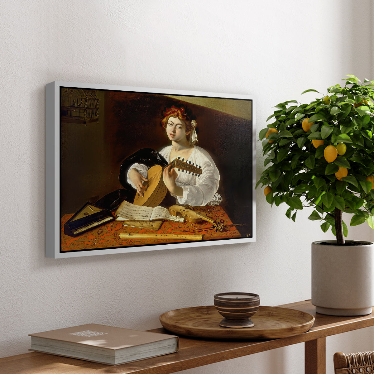 The Lute Player (Wildenstein Version), c. 1596 by Caravaggio, presented in a white floater framed canvas featuring a young man playing lute surrounded by sheet music and still life objects, displayed above a hallway console table.