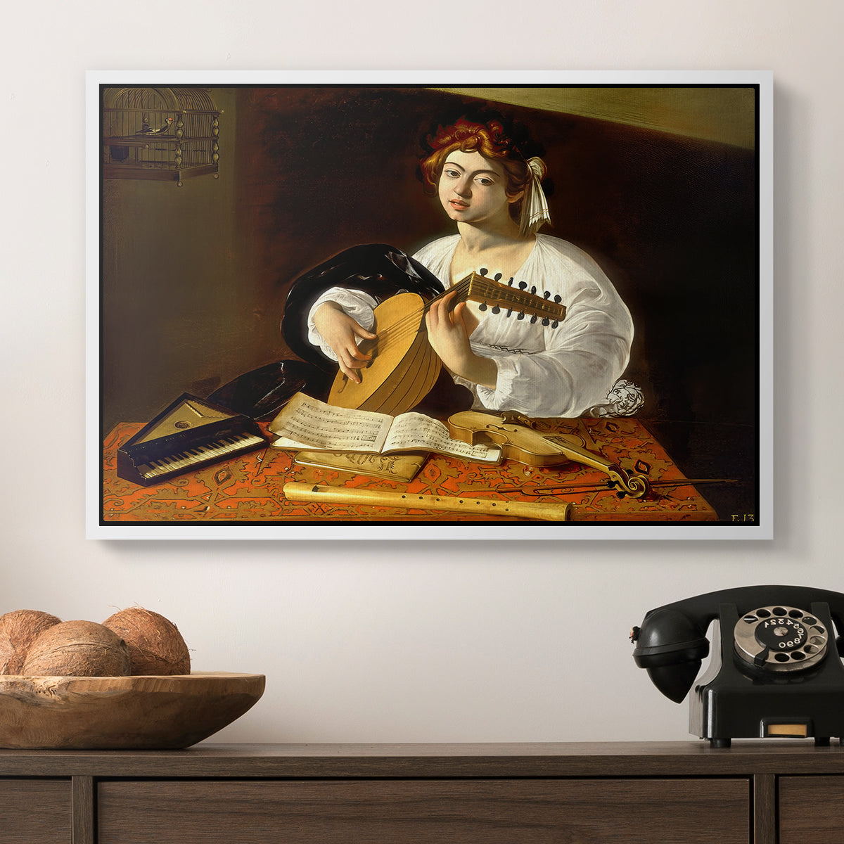 The Lute Player (Wildenstein Version), c. 1596 by Caravaggio in a white floater framed canvas displayed above a console table in a hallway, featuring an intimate portrait of musician with still life elements.
