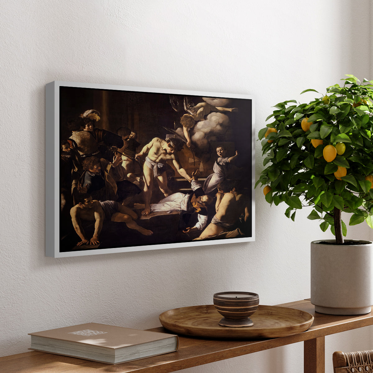 The Martyrdom of Saint Matthew, 1599-1600 by Caravaggio, presented in a white floater framed canvas featuring a chaotic scene of Saint Matthew being attacked by executioner in church, displayed above a hallway console table.