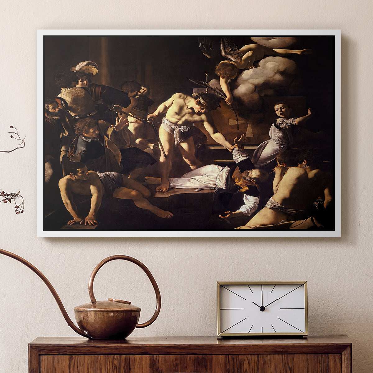 White floater framed canvas featuring a religious narrative showing violent attack on saint in crowded setting, displayed above a cabinet in a soft-toned living room.