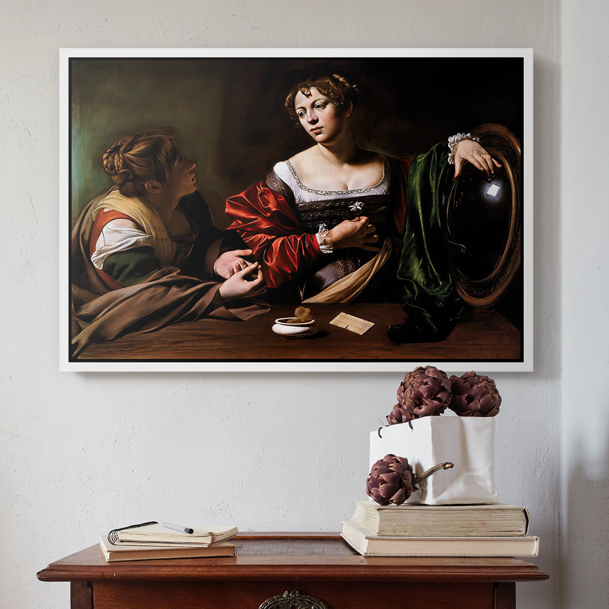 White floater framed canvas featuring Martha and Mary Magdalene, c. 1598 by Caravaggio above an entryway table in a minimalist foyer.