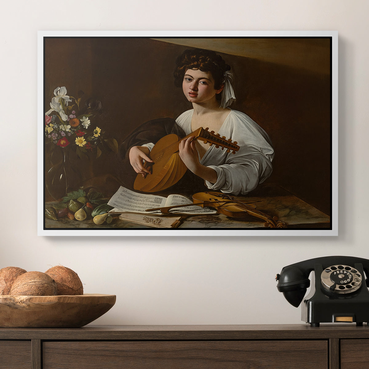 The Lute Player (Hermitage Version), c. 1596 by Caravaggio in a white floater framed canvas displayed above a console table in a hallway, featuring a Baroque depiction of musician with detailed textures and lighting.