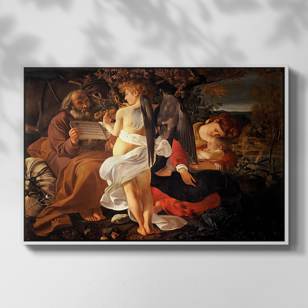 Front view of Rest on the Flight into Egypt, c. 1597 by Caravaggio in a white floater framed canvas.