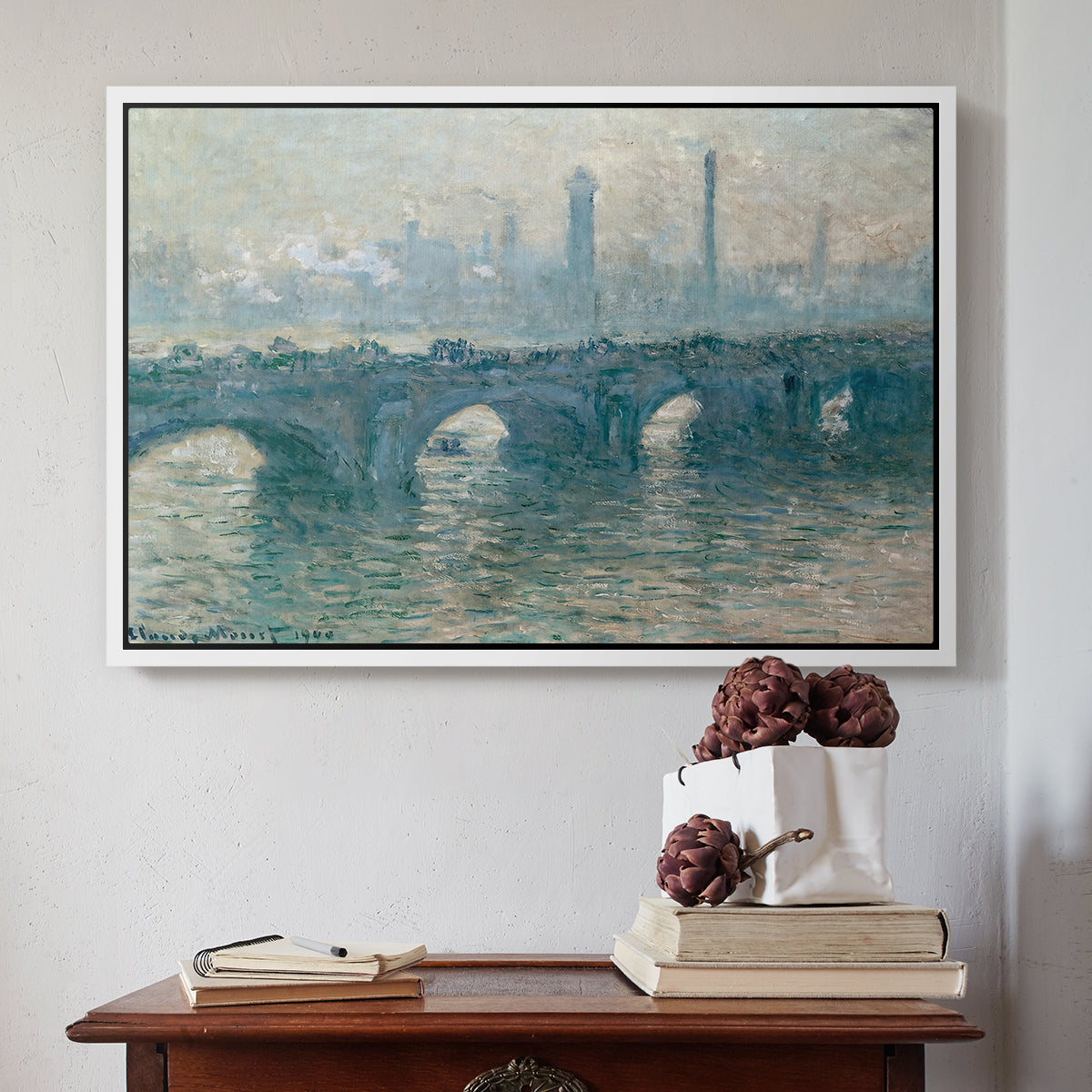 White floater framed canvas featuring Waterloo Bridge, Gray Weather, 1900 by Claude Monet above an entryway table in a minimalist foyer.
