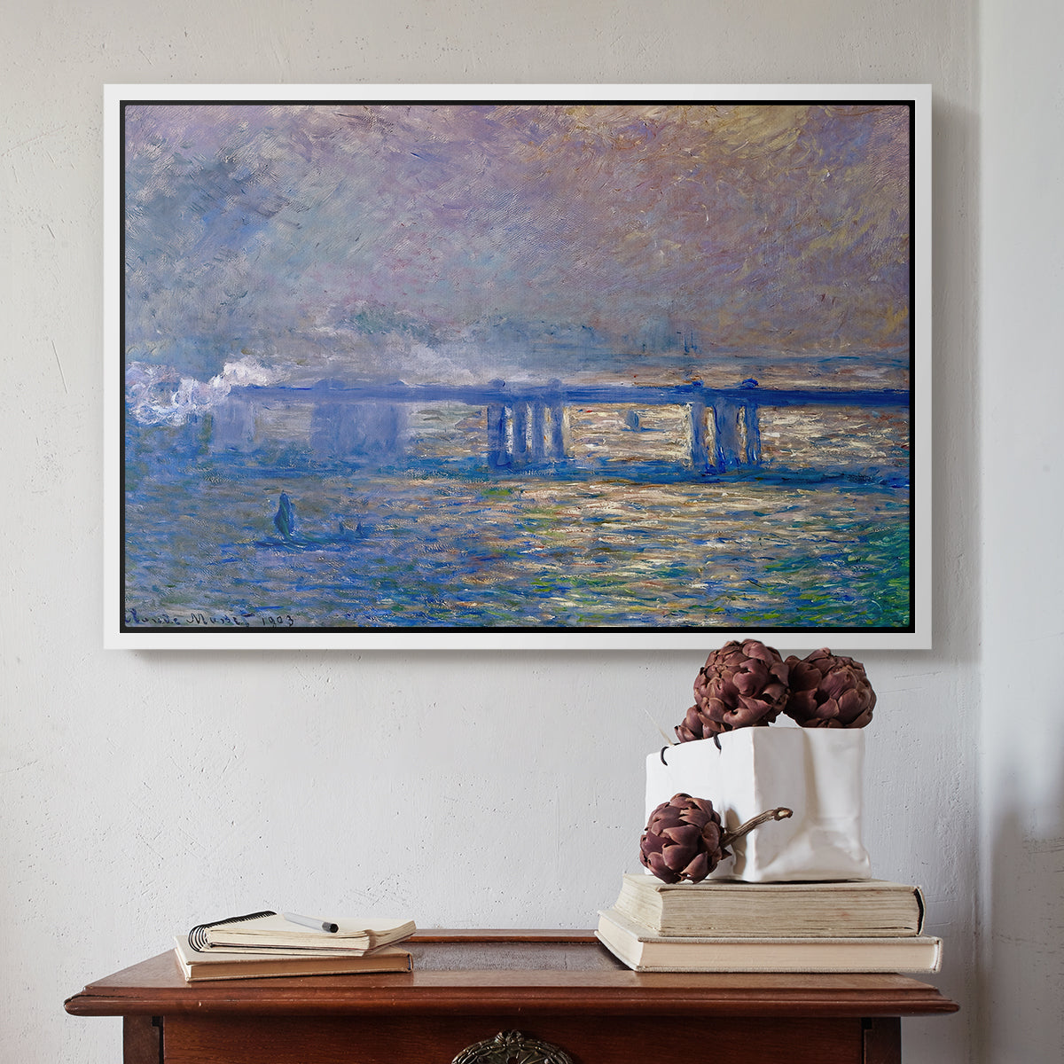 White floater framed canvas featuring Charing Cross Bridge, 1903 by Claude Monet above an entryway table in a minimalist foyer.