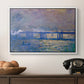 Charing Cross Bridge, 1903 by Claude Monet in a white floater framed canvas displayed above a console table in a hallway, featuring a city bridge scene softened by mist and impressionist brushwork.