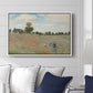 The Poppy Field near Argenteuil, 1873 by Claude Monet displayed above a sofa in a living room in a white floater frame, featuring an impressionist countryside scene with flowers and strolling figures.