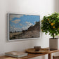 The Beach at Honfleur, 1864 by Claude Monet, presented in a white floater framed canvas featuring a coastal beach scene with figures gathered along shoreline and boats nearby, displayed above a hallway console table.