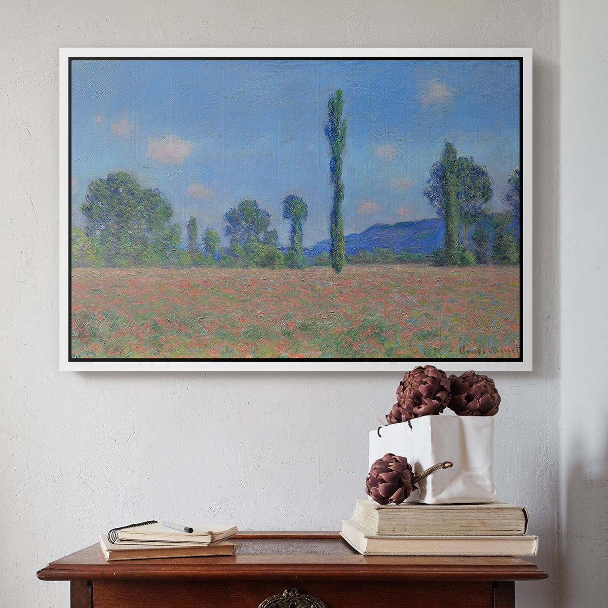 White floater framed canvas featuring Poppy Field (Giverny), 1890-1891 by Claude Monet above an entryway table in a minimalist foyer.