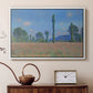White floater framed canvas featuring a vibrant meadow scene with flowers and vertical tree forms, displayed above a cabinet in a soft-toned living room.