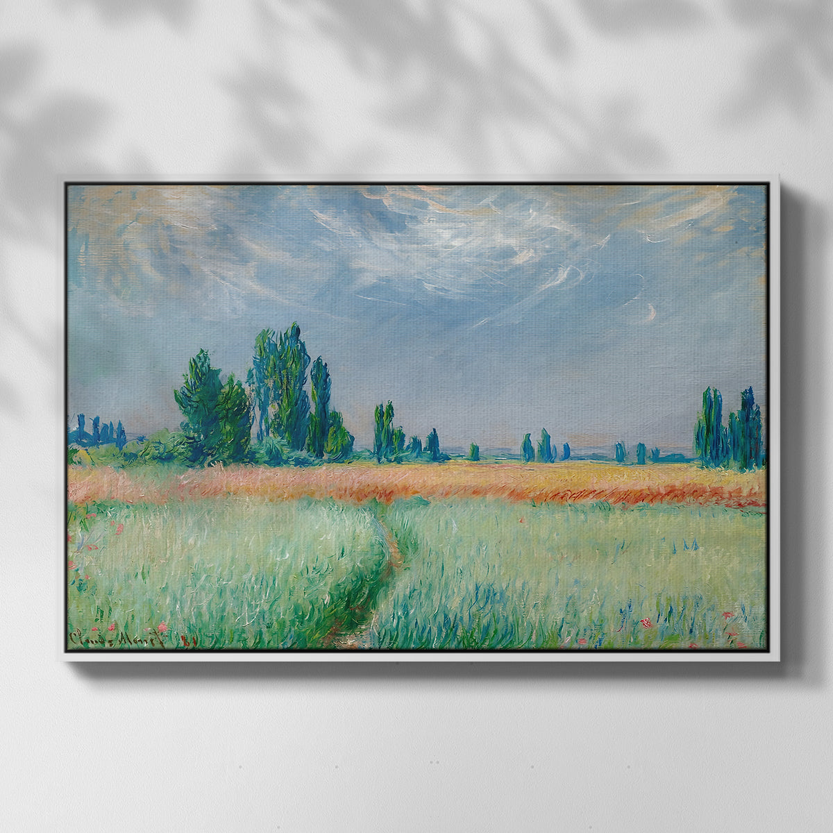Front view of The Wheat Field (Champ de Blé), 1881 by Claude Monet in a white floater framed canvas.