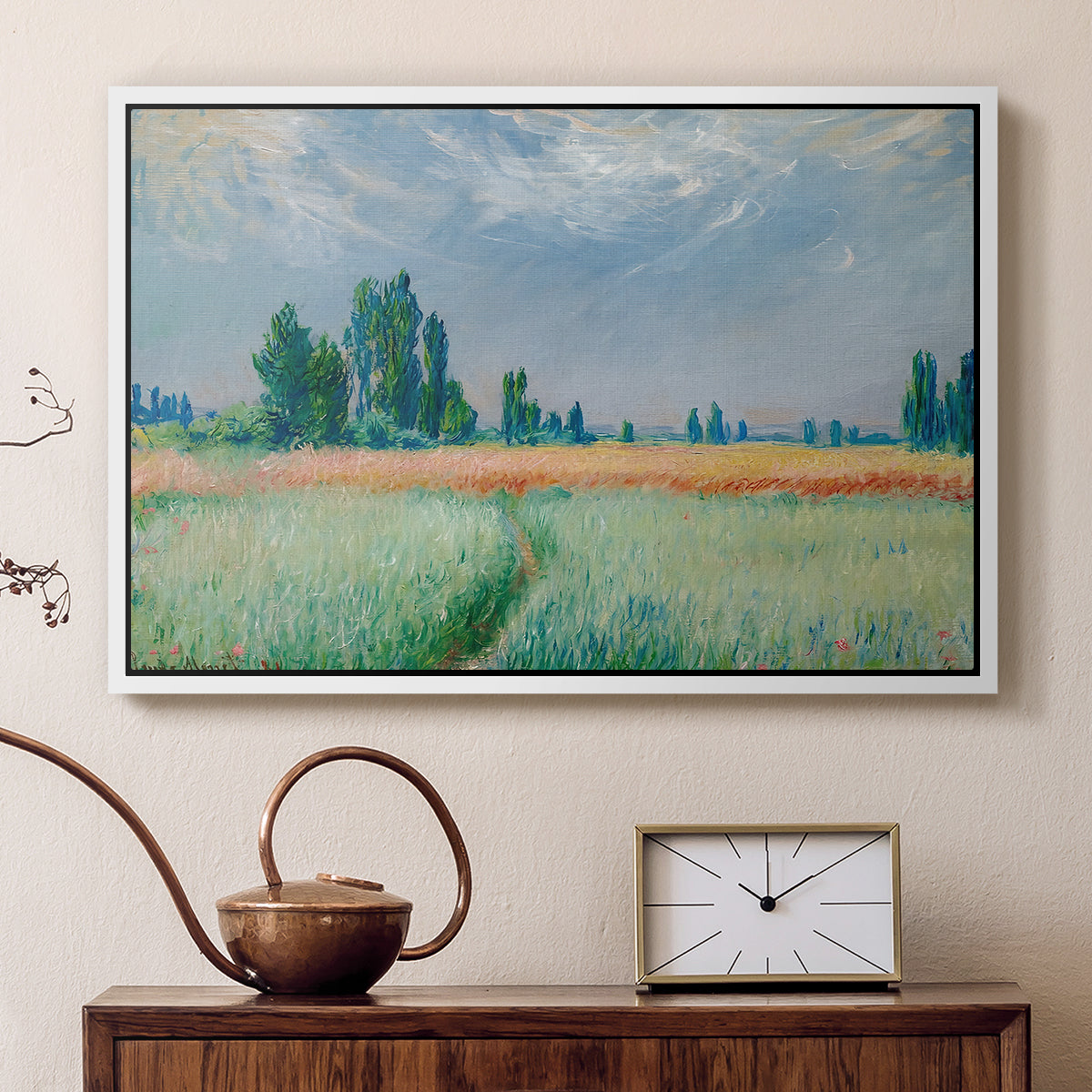 White floater framed canvas featuring an agricultural landscape with tall wheat and distant horizon, displayed above a cabinet in a soft-toned living room.