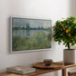 Banks of the Seine, Vétheuil, 1880 by Claude Monet, presented in a white floater framed canvas featuring a riverbank landscape with water, trees, and distant village buildings, displayed above a hallway console table.