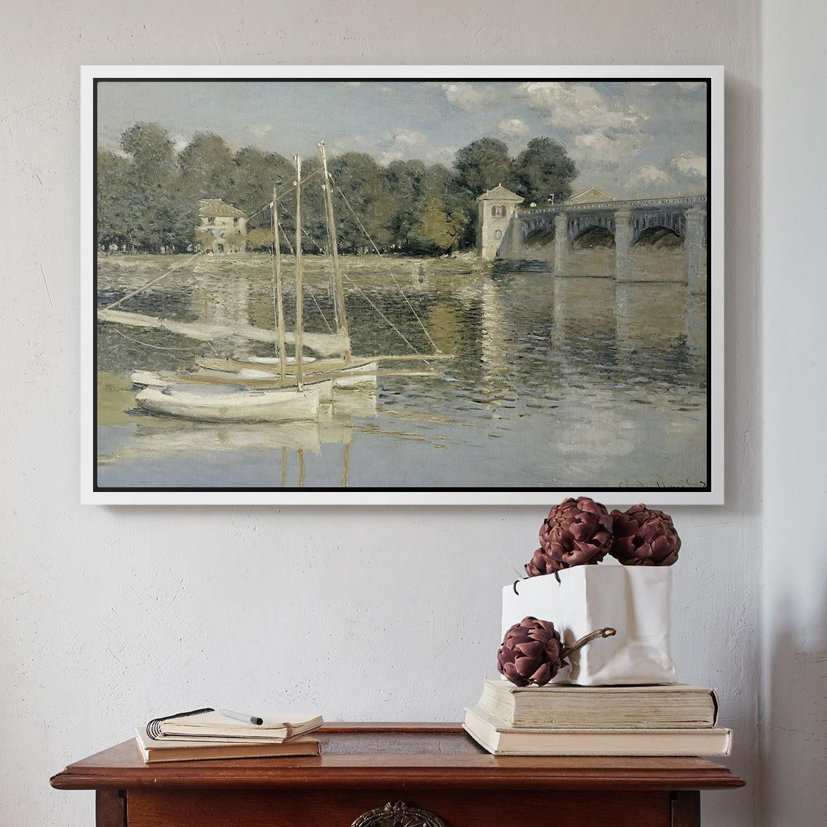 White floater framed canvas featuring The Bridge at Argenteuil, 1874 by Claude Monet above an entryway table in a minimalist foyer.