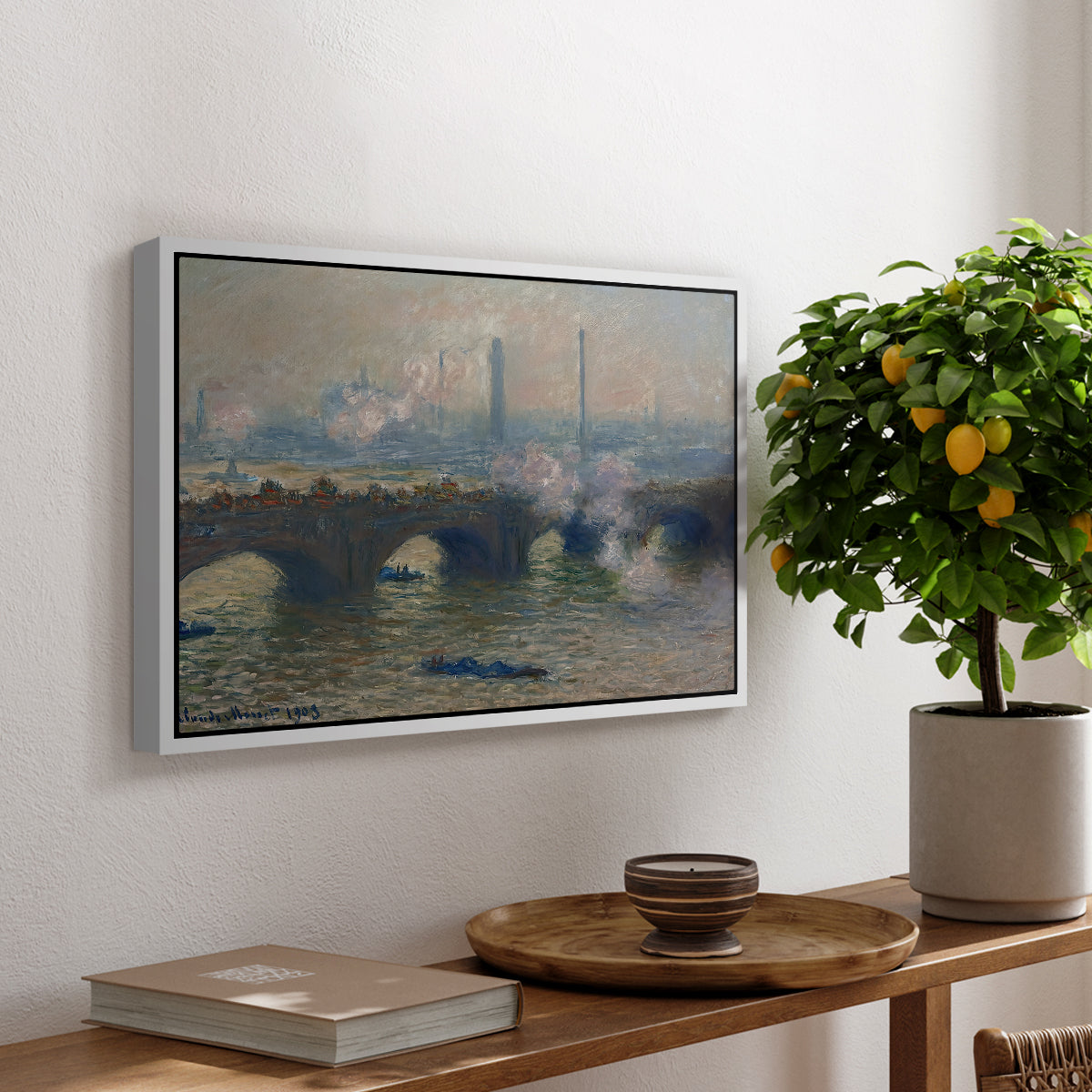 Waterloo Bridge, Gray Day, 1903 by Claude Monet, presented in a white floater framed canvas featuring a muted cityscape of bridge spanning river under overcast sky, displayed above a hallway console table.