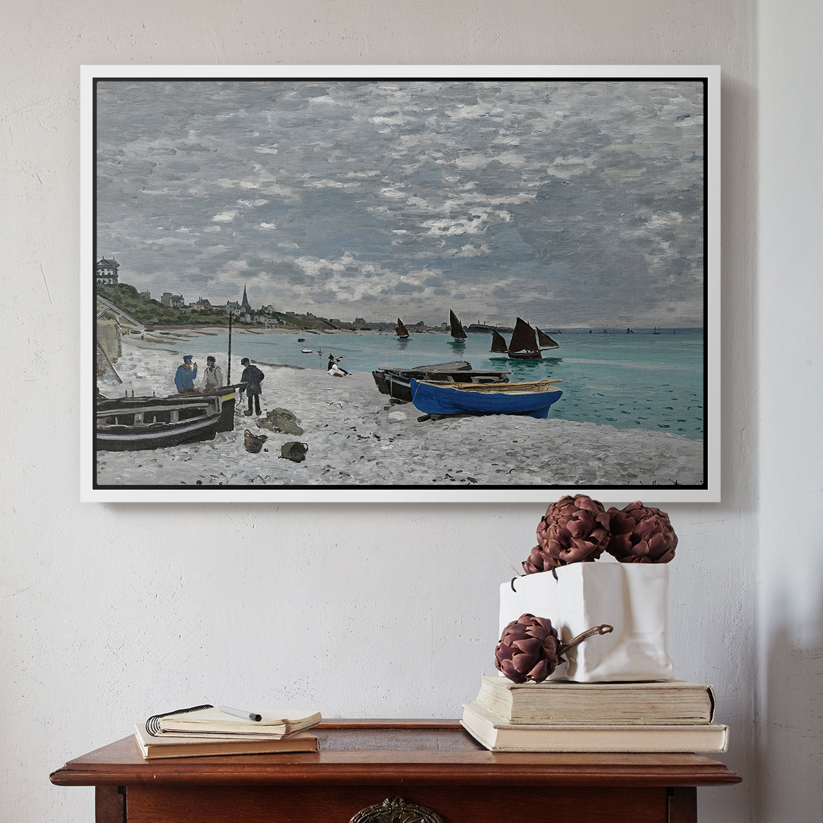 White floater framed canvas featuring The Beach at Sainte-Adresse, 1867 by Claude Monet above an entryway table in a minimalist foyer.