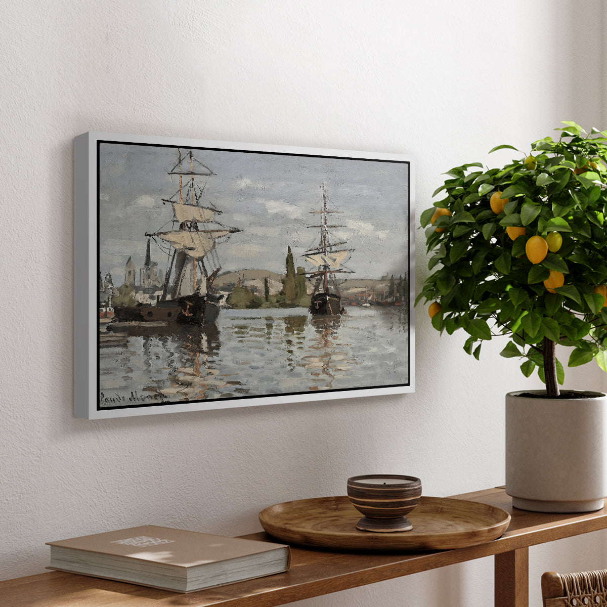 Ships Riding on the Seine at Rouen, 1872 by Claude Monet, presented in a white floater framed canvas featuring large ships docked along the Seine with masts rising against soft sky, displayed above a hallway console table.