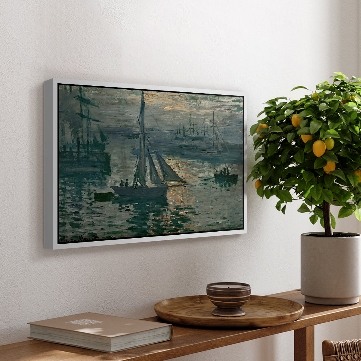 Sunrise (Marine), 1873 by Claude Monet, presented in a white floater framed canvas featuring a hazy sunrise over harbor with boats silhouetted in soft morning light, displayed above a hallway console table.