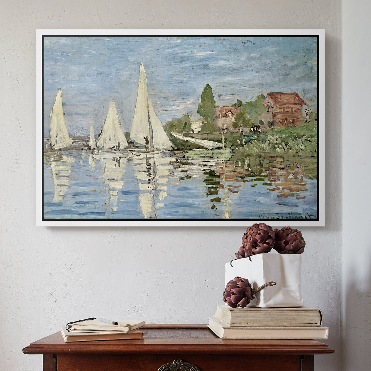 White floater framed canvas featuring Regatta at Argenteuil, 1872 by Claude Monet above an entryway table in a minimalist foyer.