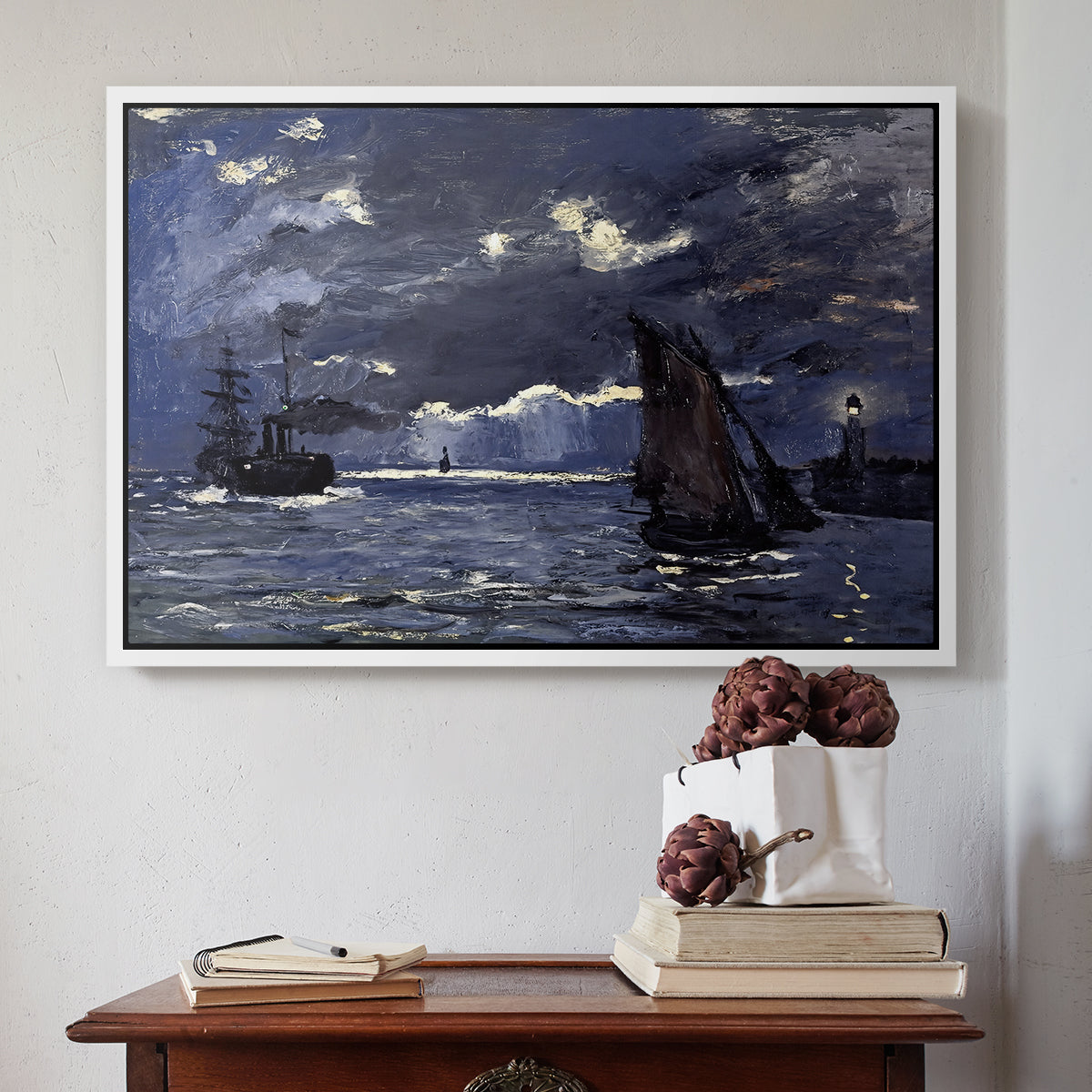 White floater framed canvas featuring A Seascape, Shipping by Moonlight, 1864 by Claude Monet above an entryway table in a minimalist foyer.